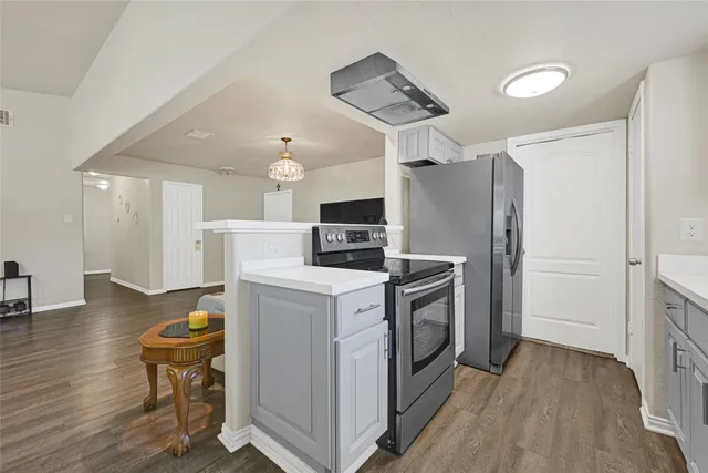 a kitchen with cabinets a sink and appliances