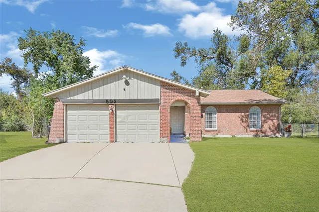 a bedroom with a bed and a flat tv screen on a dresser