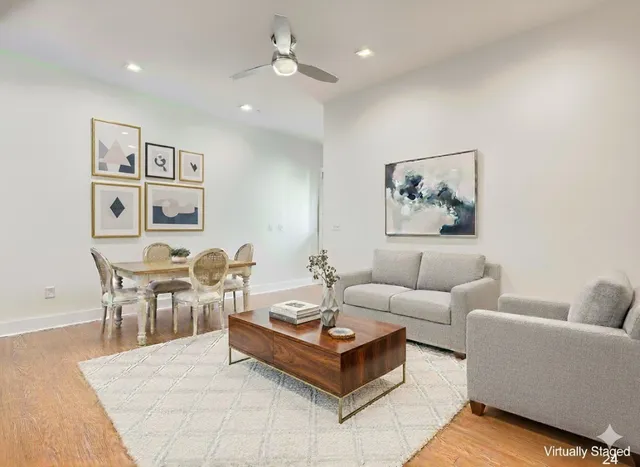 a living room with furniture potted plant and white walls