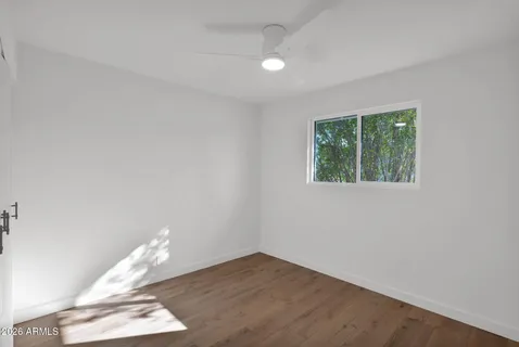 a view of a room with wooden floor and white walls