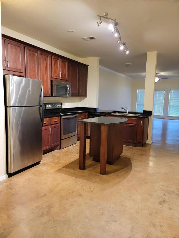 910 West 25th Street, Unit 305 Austin, TX 78705 - Photo 2 of 10 a kitchen with stainless steel appliances granite countertop a refrigerator a stove top oven a sink and dishwasher