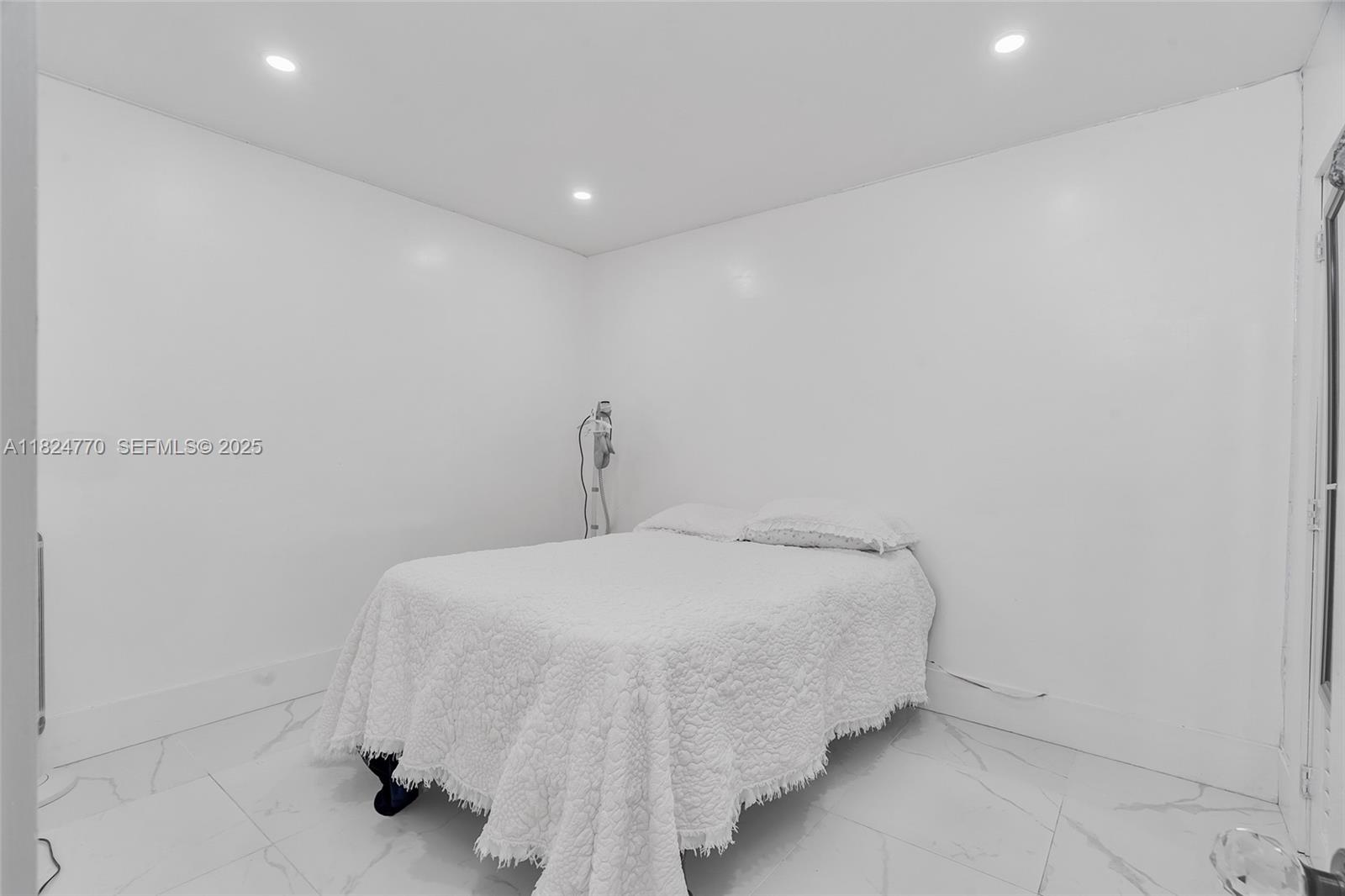 31 Southwest 58th Court Miami, FL 33144 - Photo 11 of 41 a bedroom with a bed and a wall painting