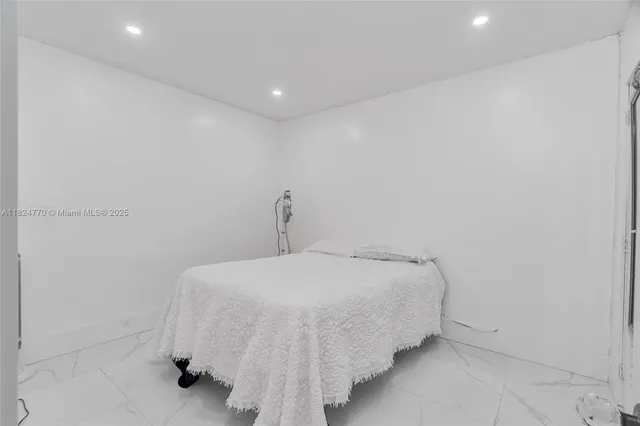 a bedroom with a bed and a wall painting