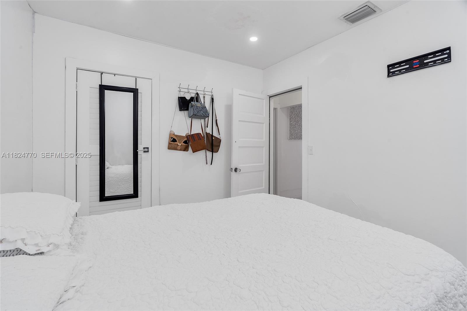 31 Southwest 58th Court Miami, FL 33144 - Photo 12 of 41 a bedroom with a bed and a window