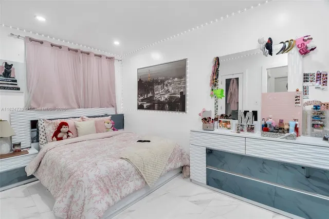 a bedroom with a bed and a dresser