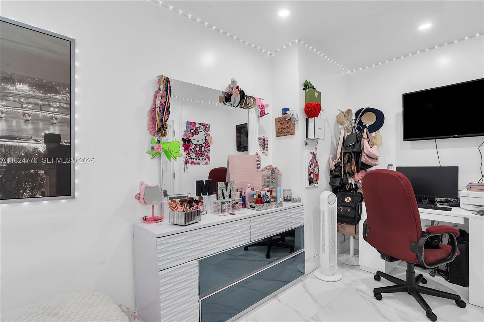 31 Southwest 58th Court Miami, FL 33144 - Photo 14 of 41 a view of a workspace with furniture and a flat screen tv