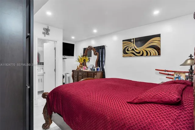 a bedroom with a bed and a view of bathroom