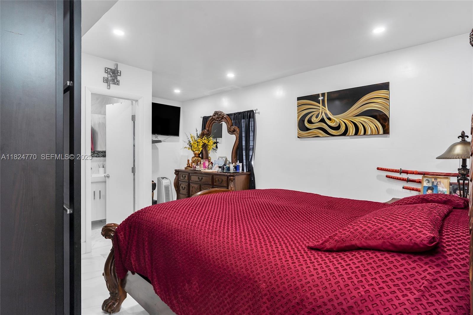 31 Southwest 58th Court Miami, FL 33144 - Photo 15 of 41 a bedroom with a bed and a view of bathroom