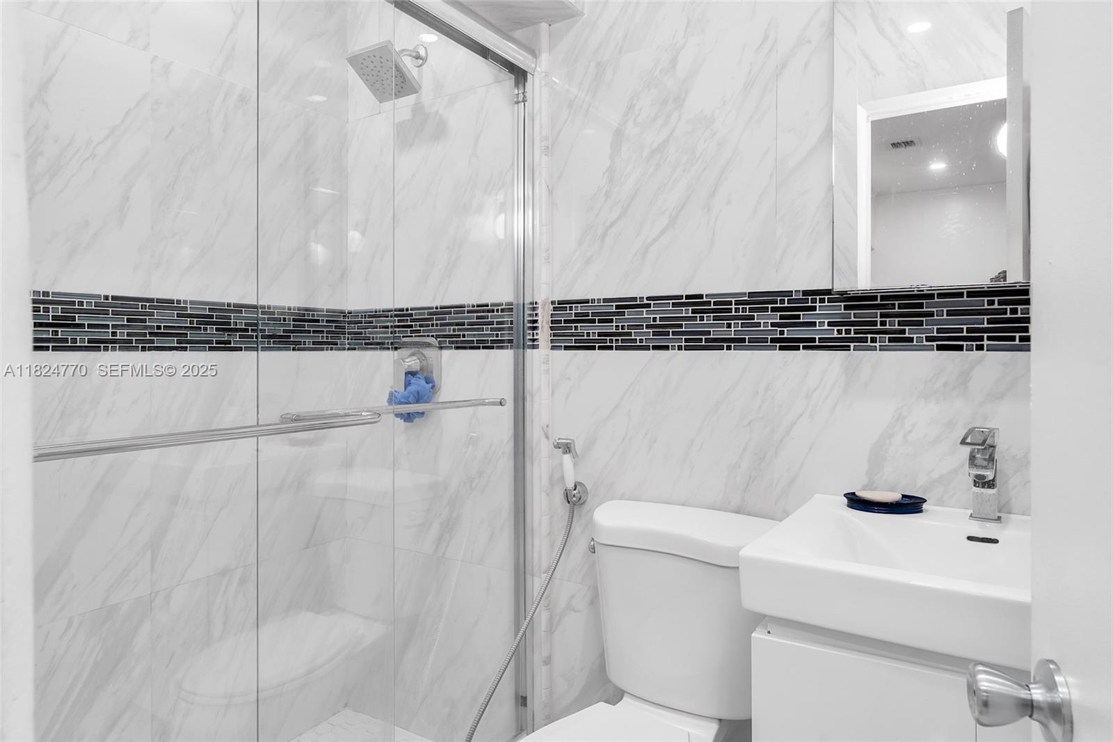 31 Southwest 58th Court Miami, FL 33144 - Photo 18 of 41 a bathroom with a sink and a mirror