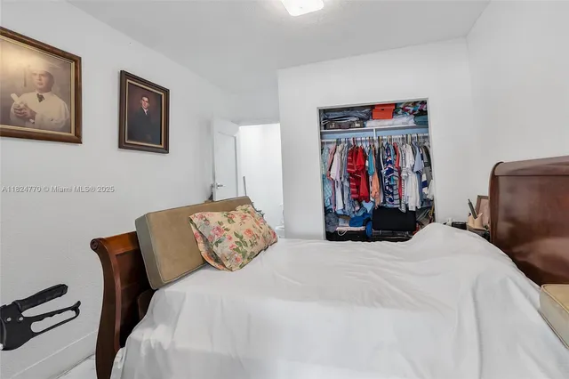 a bed room with a bed and a chair