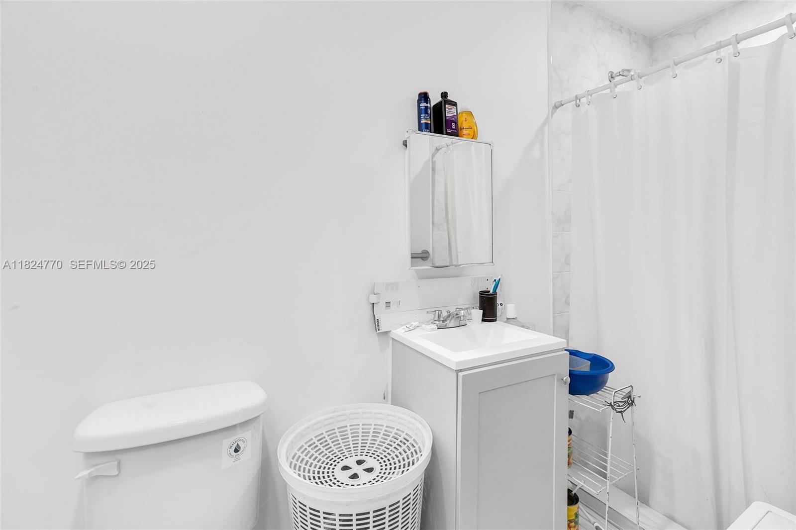 31 Southwest 58th Court Miami, FL 33144 - Photo 21 of 41 a bathroom with a sink a toilet and a mirror