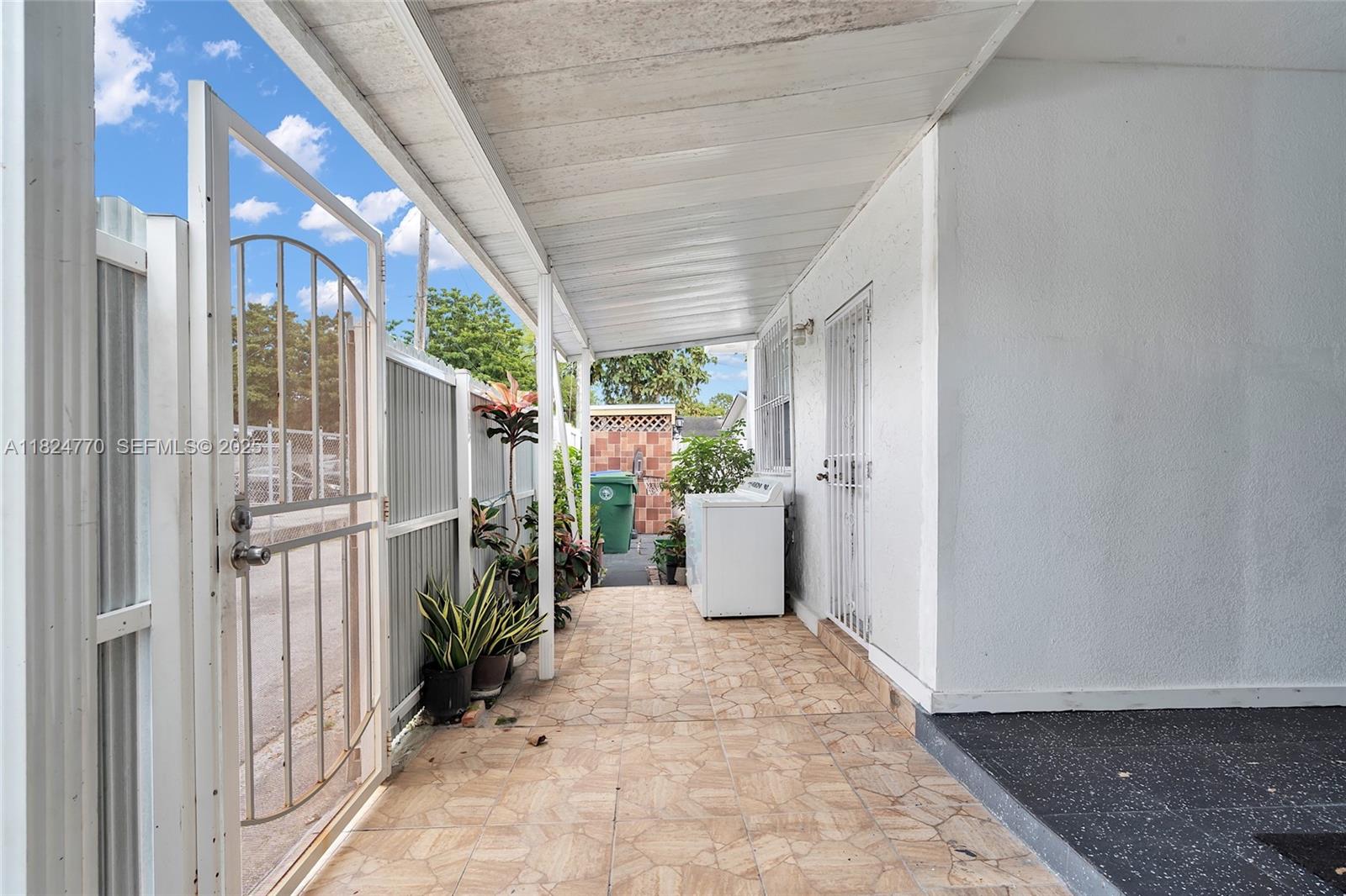 31 Southwest 58th Court Miami, FL 33144 - Photo 24 of 41 a view of a porch with furniture and front door
