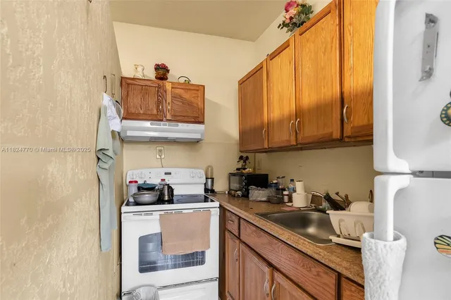 a bathroom with a sink mirror vanity and toilet