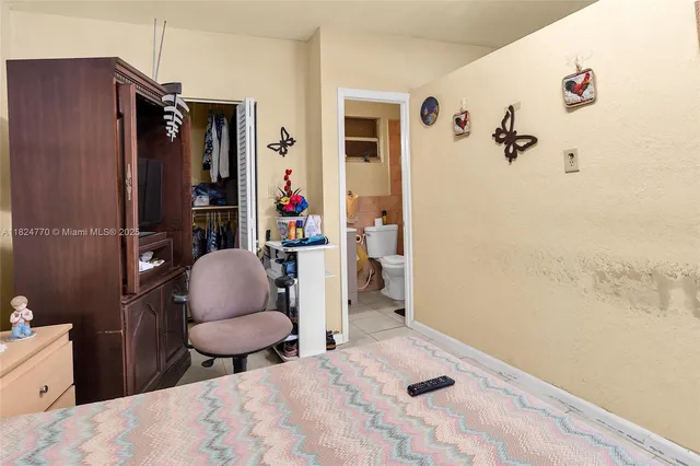 a bathroom with a sink a toilet and shower curtain
