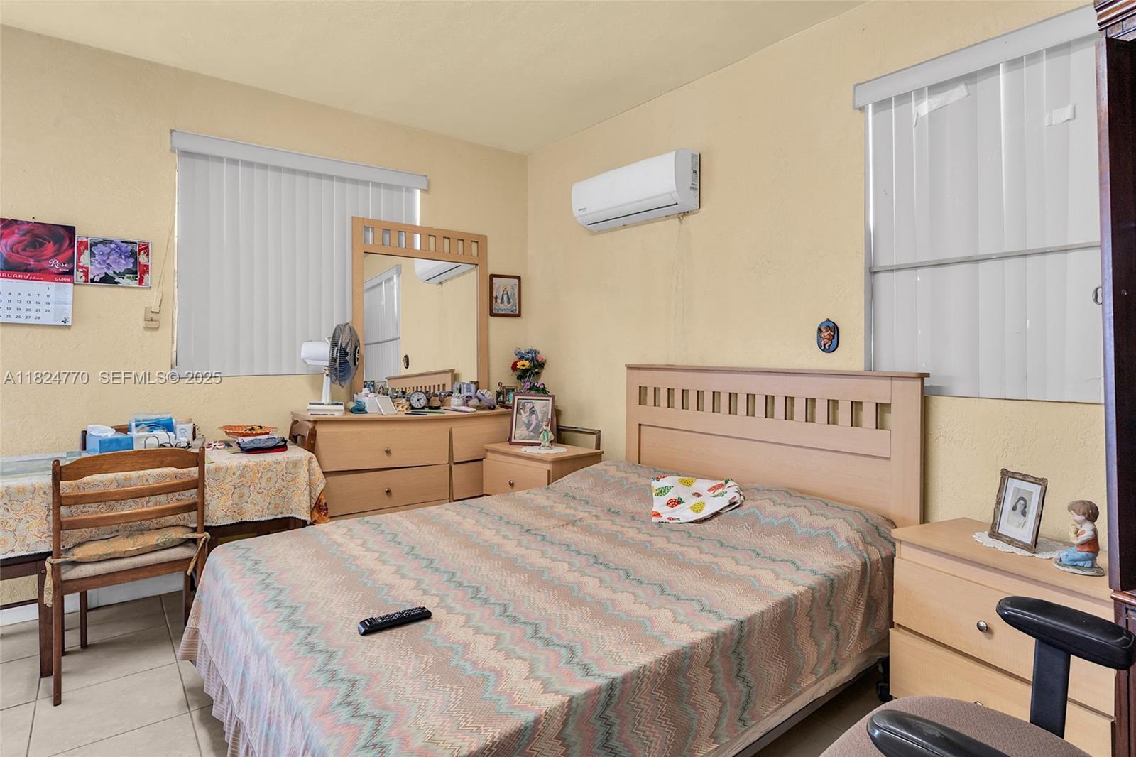 31 Southwest 58th Court Miami, FL 33144 - Photo 36 of 41 a bedroom with a bed and a table in it