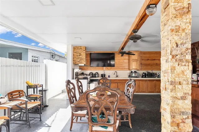a dining room with furniture and a floor to ceiling window