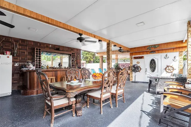 a kitchen with stainless steel appliances kitchen island granite countertop a table and chairs in it