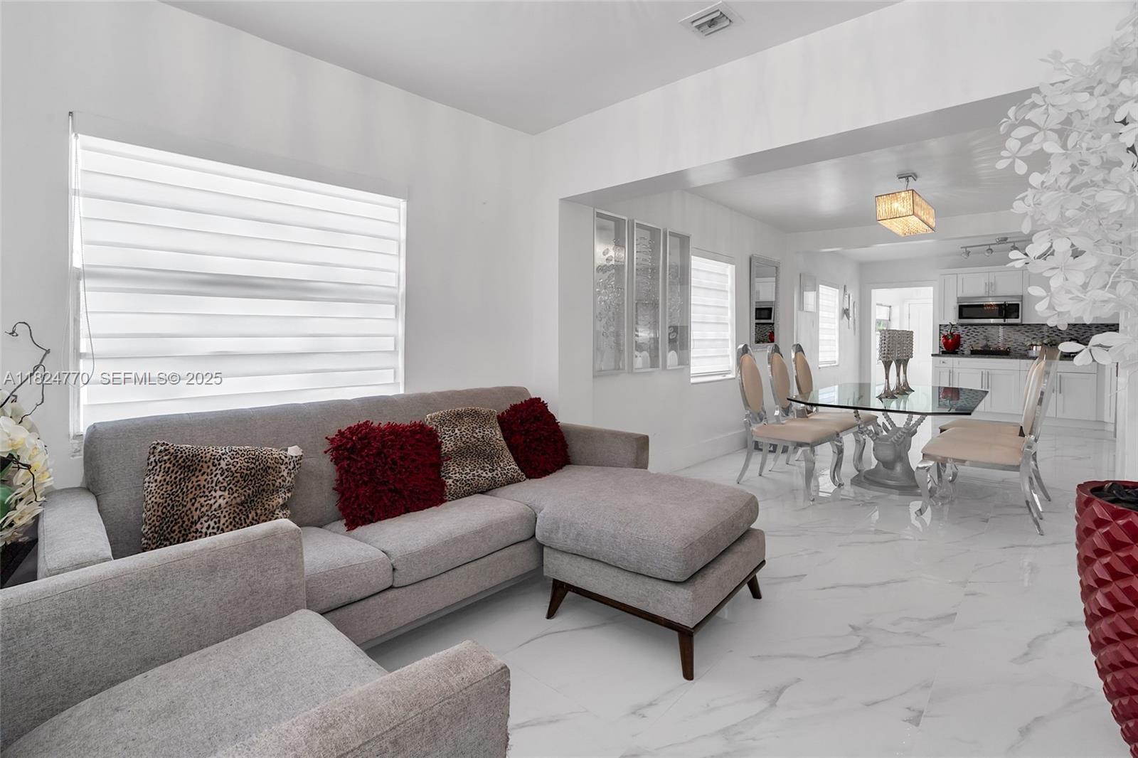 31 Southwest 58th Court Miami, FL 33144 - Photo 4 of 41 a living room with furniture and a large window