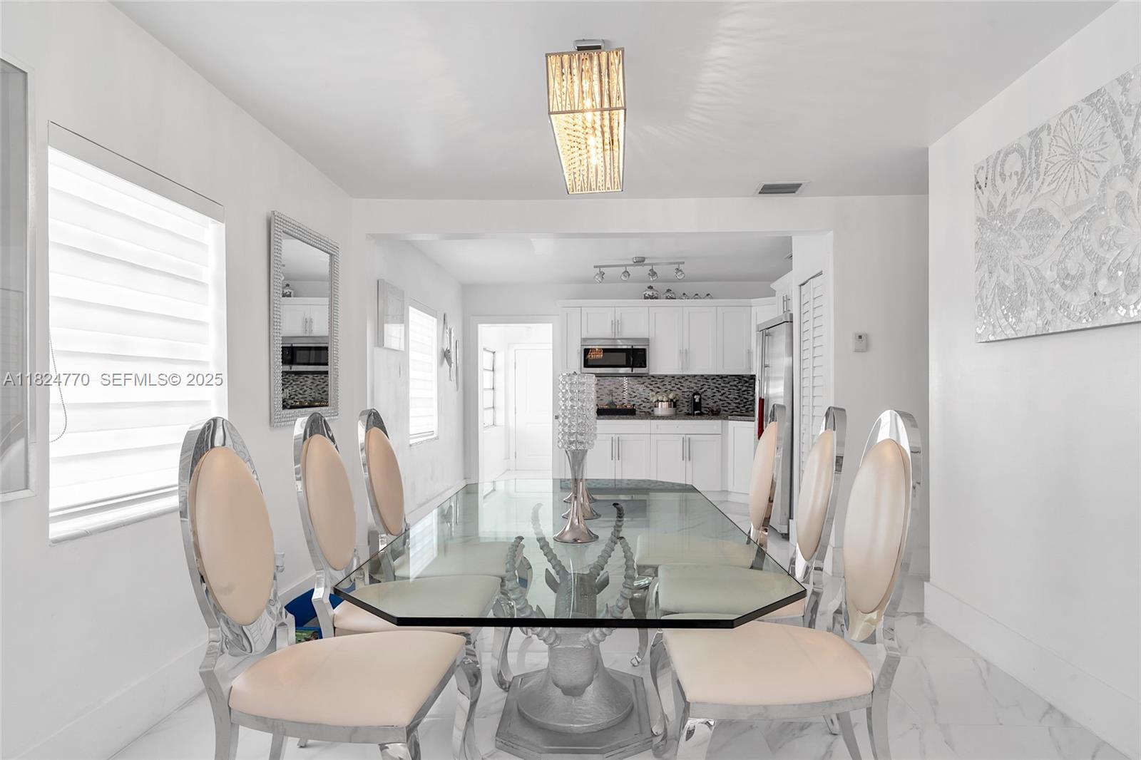 31 Southwest 58th Court Miami, FL 33144 - Photo 8 of 41 a view of a dining room with furniture and wooden floor