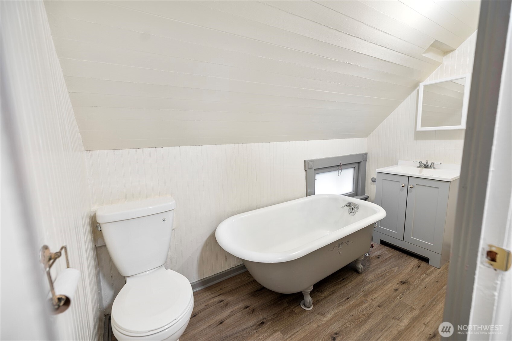 5241 South M Street, Unit AB Tacoma, WA 98408 - Photo 18 of 27 a white toilet sitting next to a bathroom sink