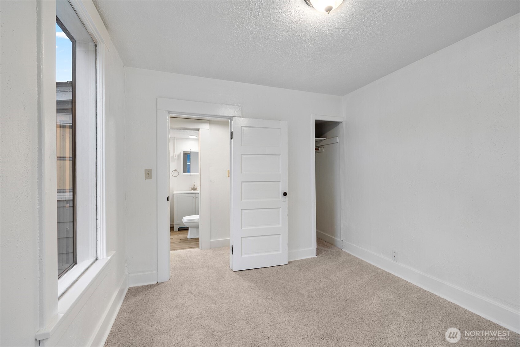 5241 South M Street, Unit AB Tacoma, WA 98408 - Photo 9 of 27 wooden floor and closet in a room