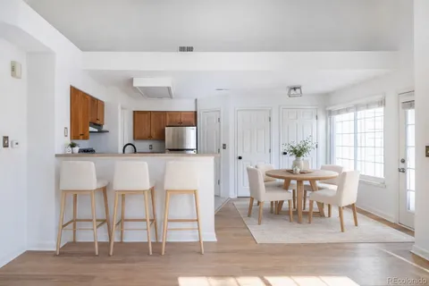 a dining room with furniture and wooden floor