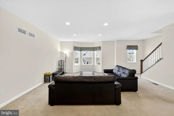 a living room with furniture and a ceiling fan