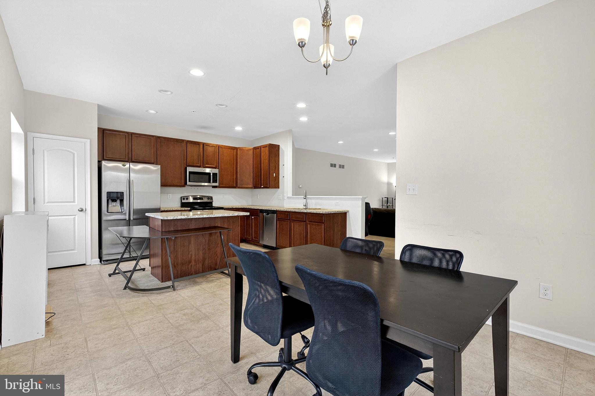 48 Munro Road Newark, DE 19711 - Photo 17 of 50 a view of kitchen with cabinets stainless steel appliances and a dining table