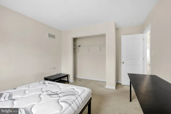 a bedroom with a bed and a chair