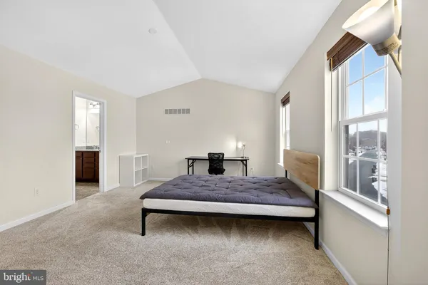 a bedroom with a bed and window