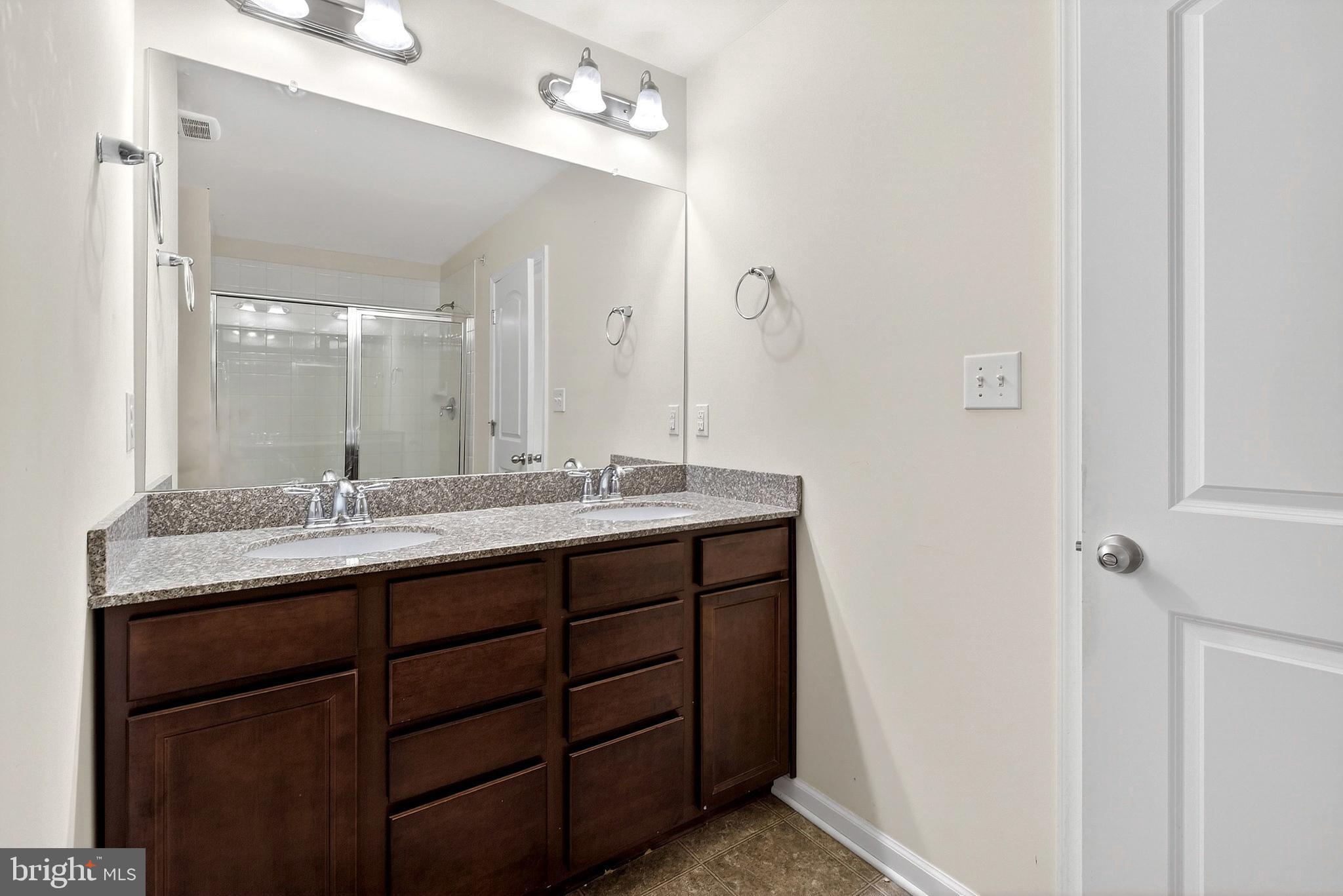 48 Munro Road Newark, DE 19711 - Photo 32 of 50 a bathroom with a granite countertop sink and a mirror