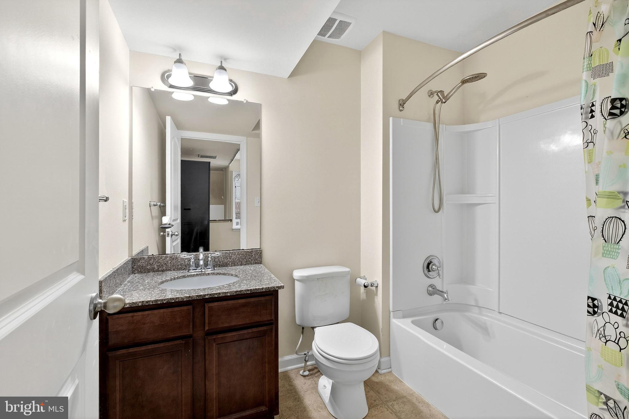 48 Munro Road Newark, DE 19711 - Photo 9 of 50 a bathroom with a granite countertop sink toilet mirror and bathtub