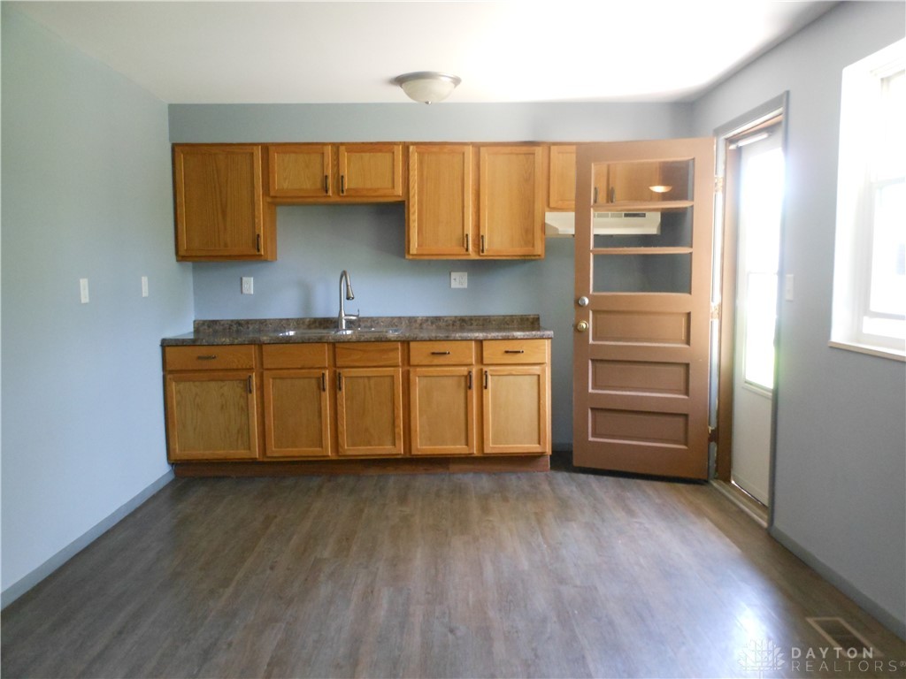 143 West Emerick Road West Milton, OH 45383 - Photo 6 of 37 This functional kitchen space offers warm wood cabinetry and durable flooring, ready for your personal touch.