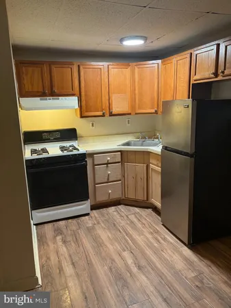 a kitchen with stainless steel appliances granite countertop a stove a refrigerator and a sink