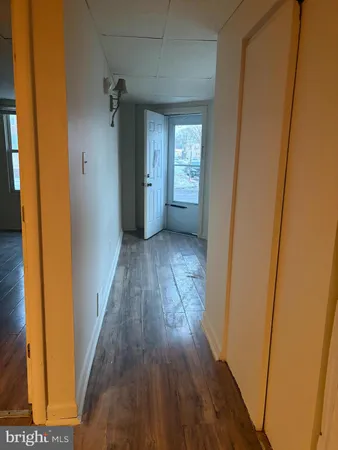 a view of hallway with wooden floor