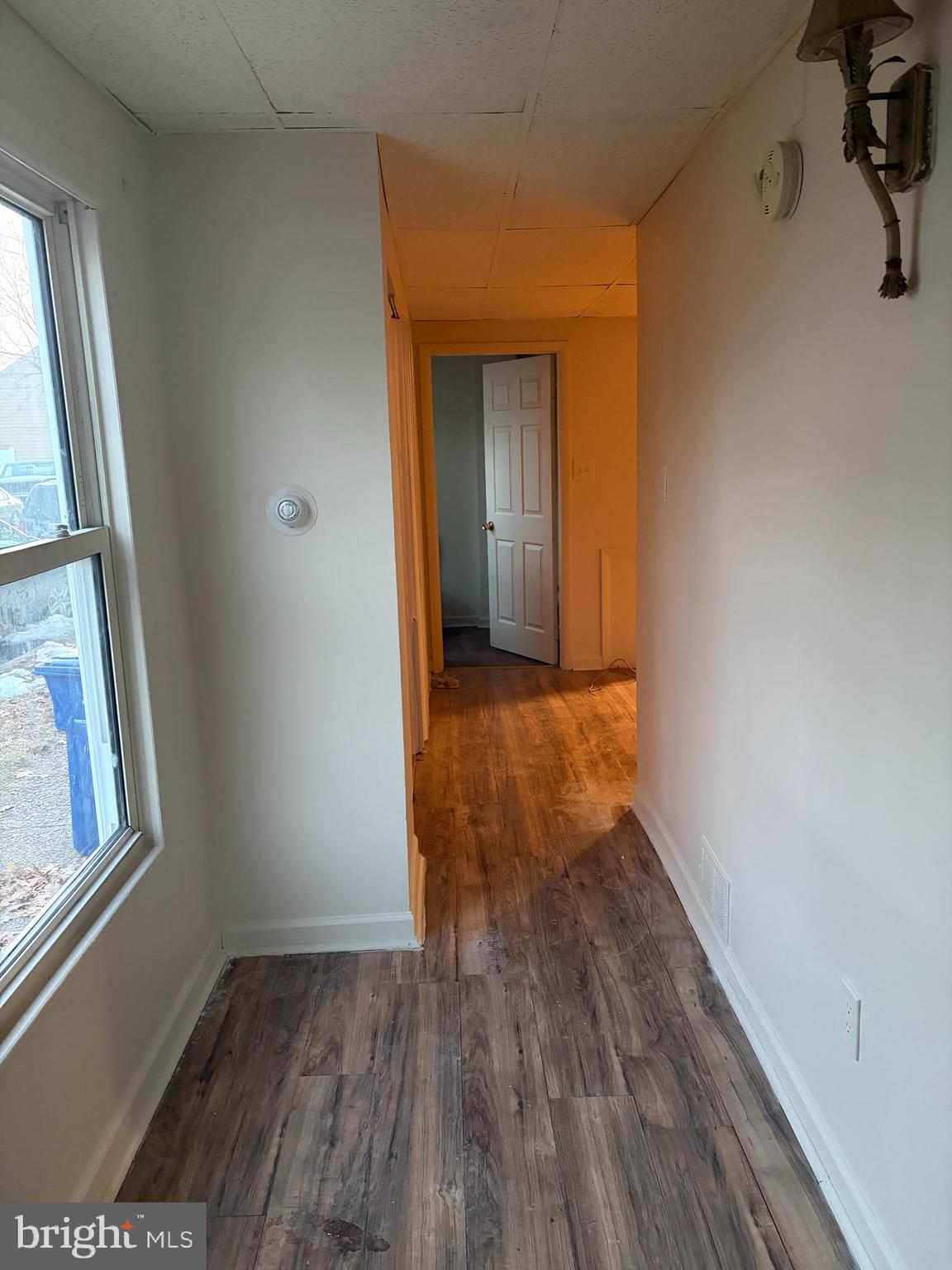 231 Broad Street, Unit C Beverly, NJ 08010 - Photo 6 of 7 a view of hallway with window and wooden floor