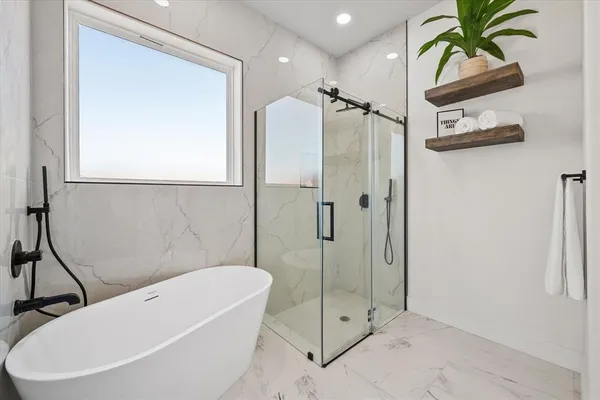 a bathroom with a bathtub and a shower