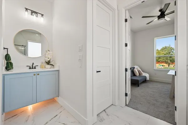a en suite bathroom with a toilet a sink and mirror