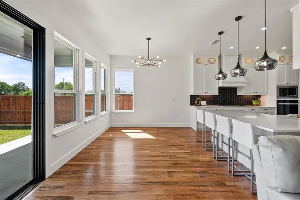 a view of a room with wooden floor and windows