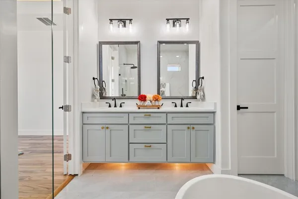 a spacious bathroom with sinks mirror and a bathtub