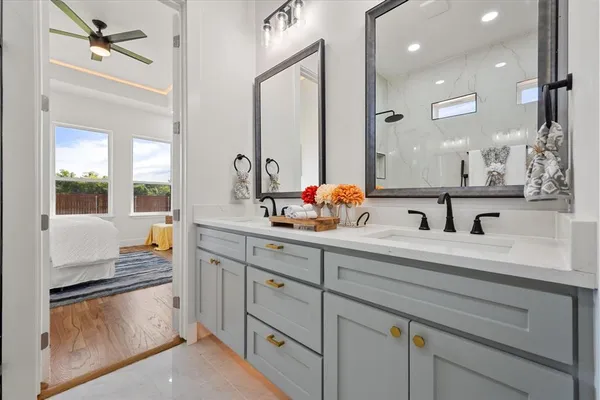 a bathroom with a sink double vanity and a mirror