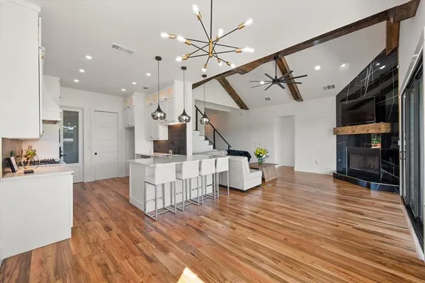 a living room with fireplace furniture and a wooden floor