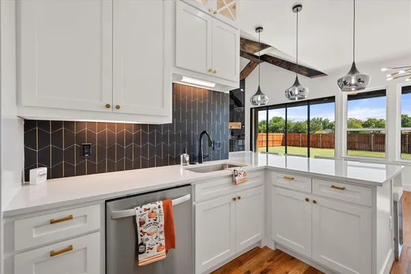 a kitchen that has a sink and a stove