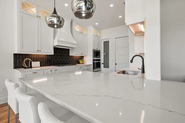 a large kitchen with a table and chairs