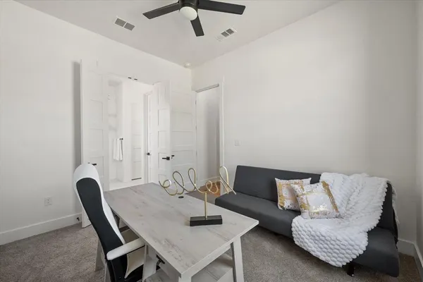 a living room with furniture and a potted plant