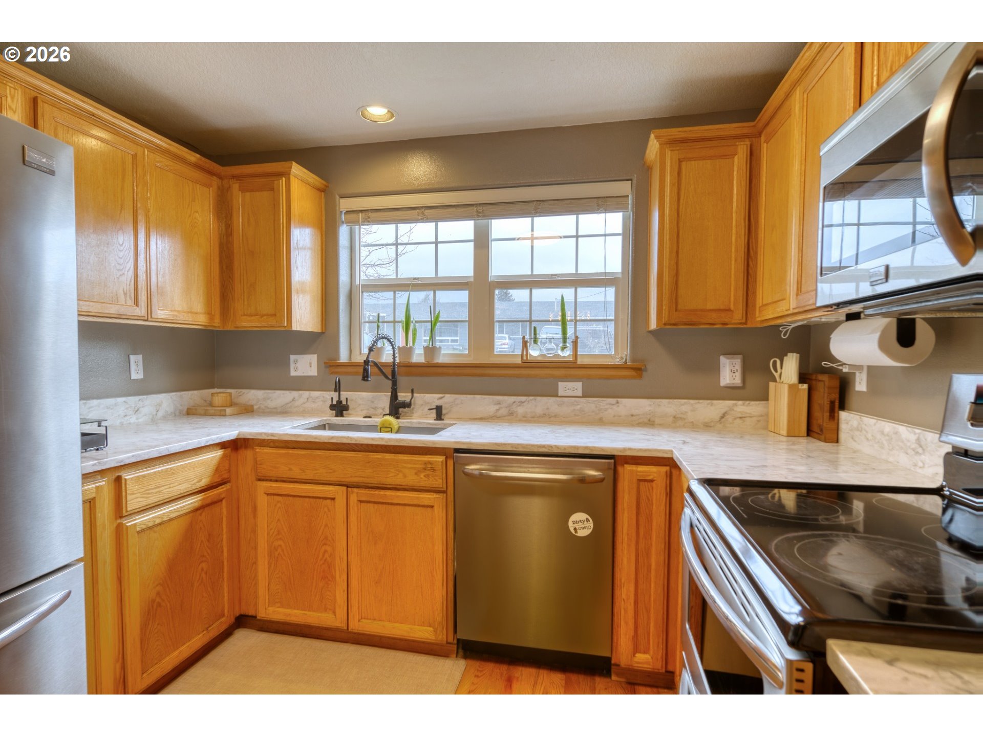 435 South 8th Street St. Helens, OR 97051 - Photo 7 of 39 a kitchen with stainless steel appliances granite countertop a sink stove and cabinets