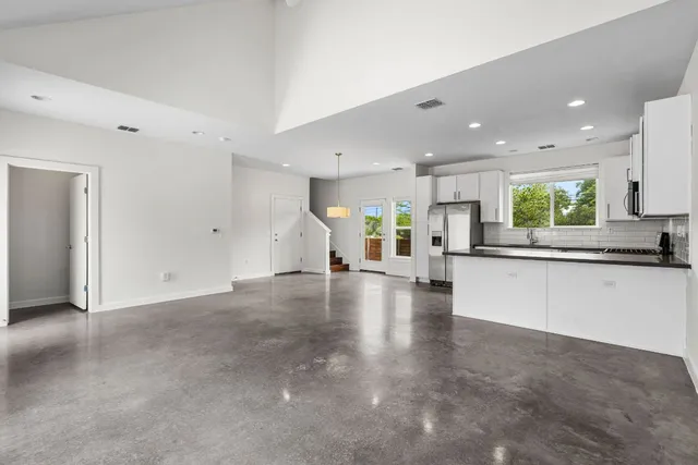 a view of wooden floor and windows in a room