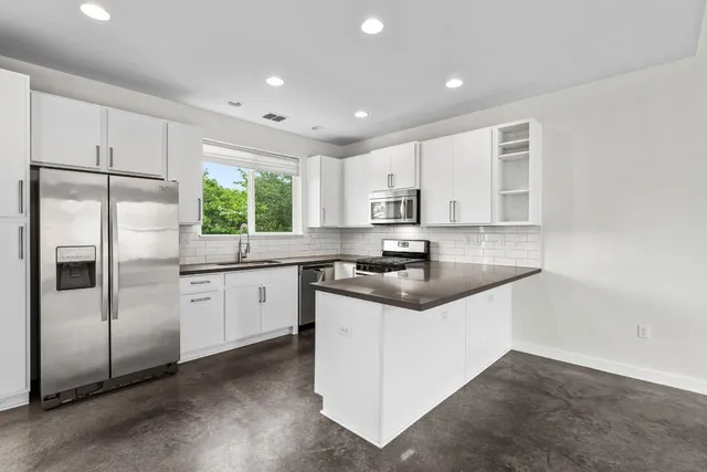 an empty room with windows and closet