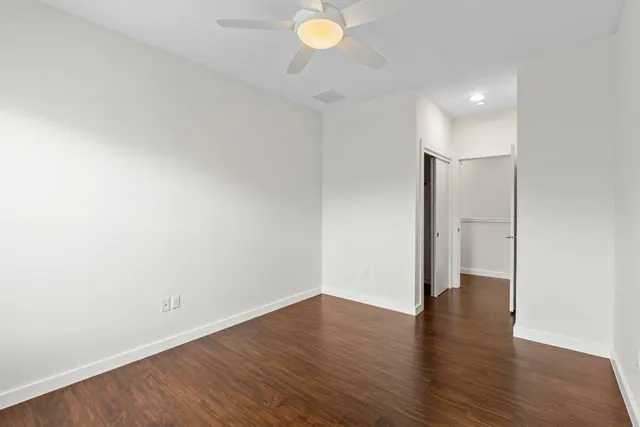a view of an empty room with wooden floor