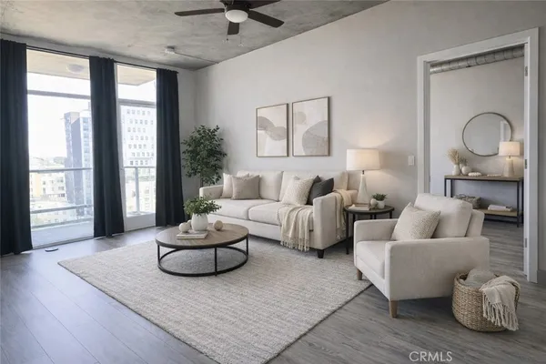 a living room with furniture potted plant and a large window